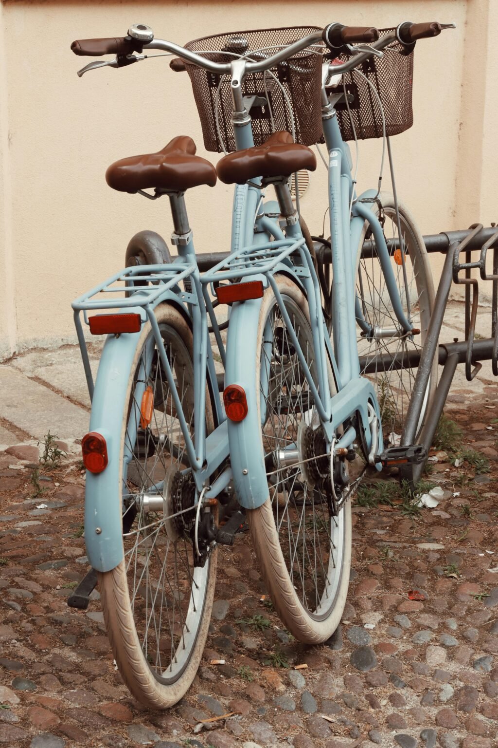 Two Blue Bikes with Baskets